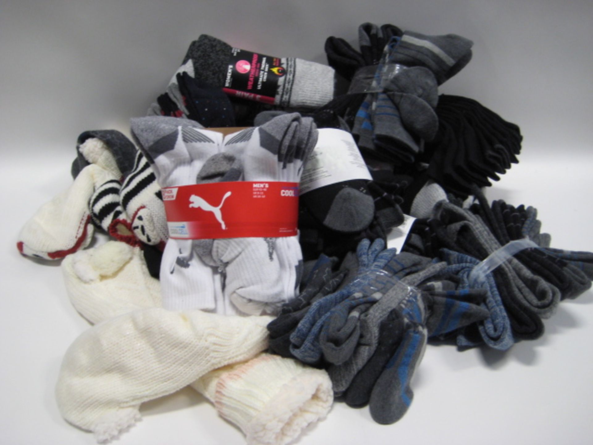 Bag of ladies and gents socks by Puma, Kirkland, Penguin and Weatherproof