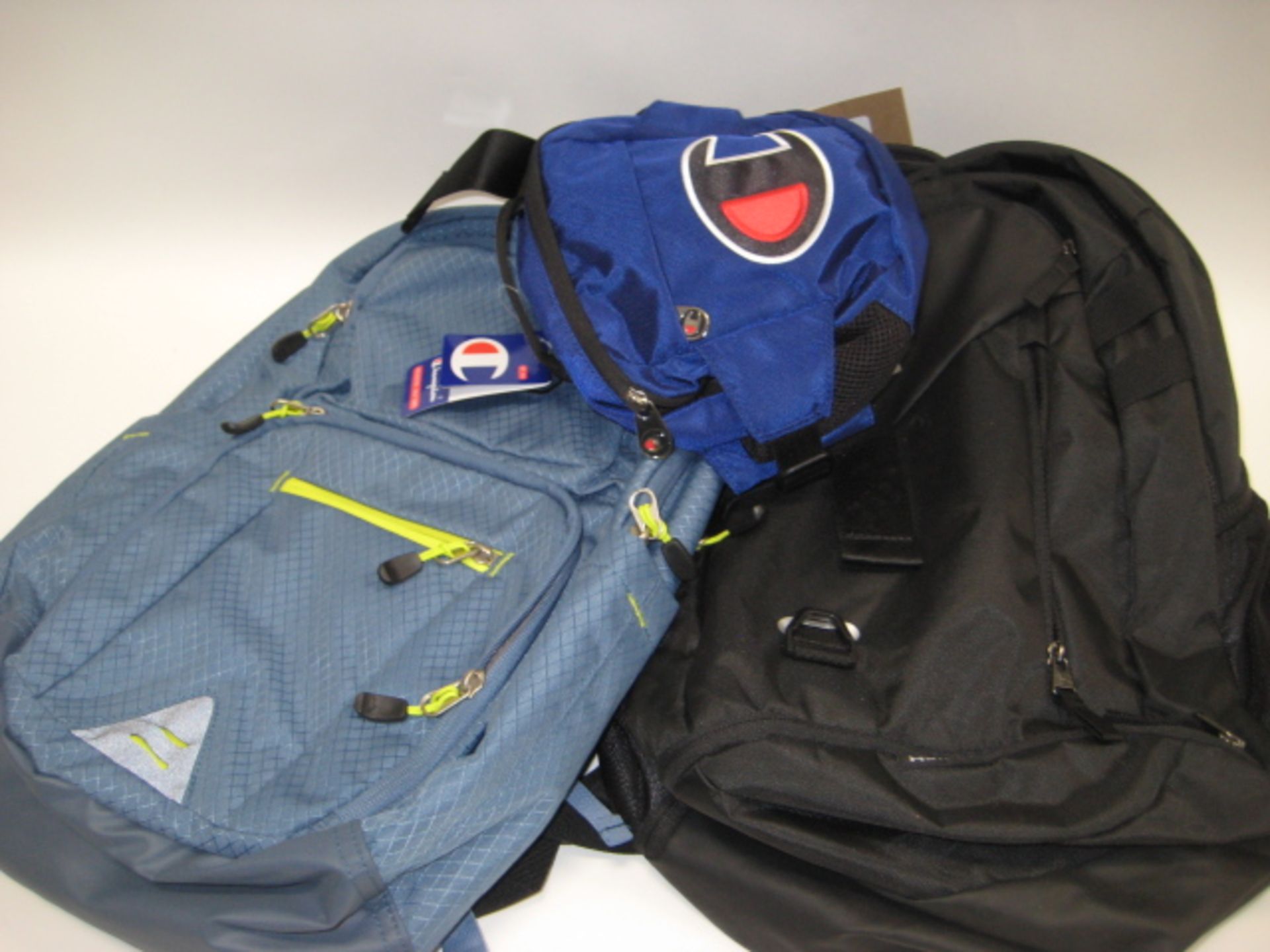 2 rucksacks, 1 by High Sierra and 1 by Under Armour with small bum bag by Champion