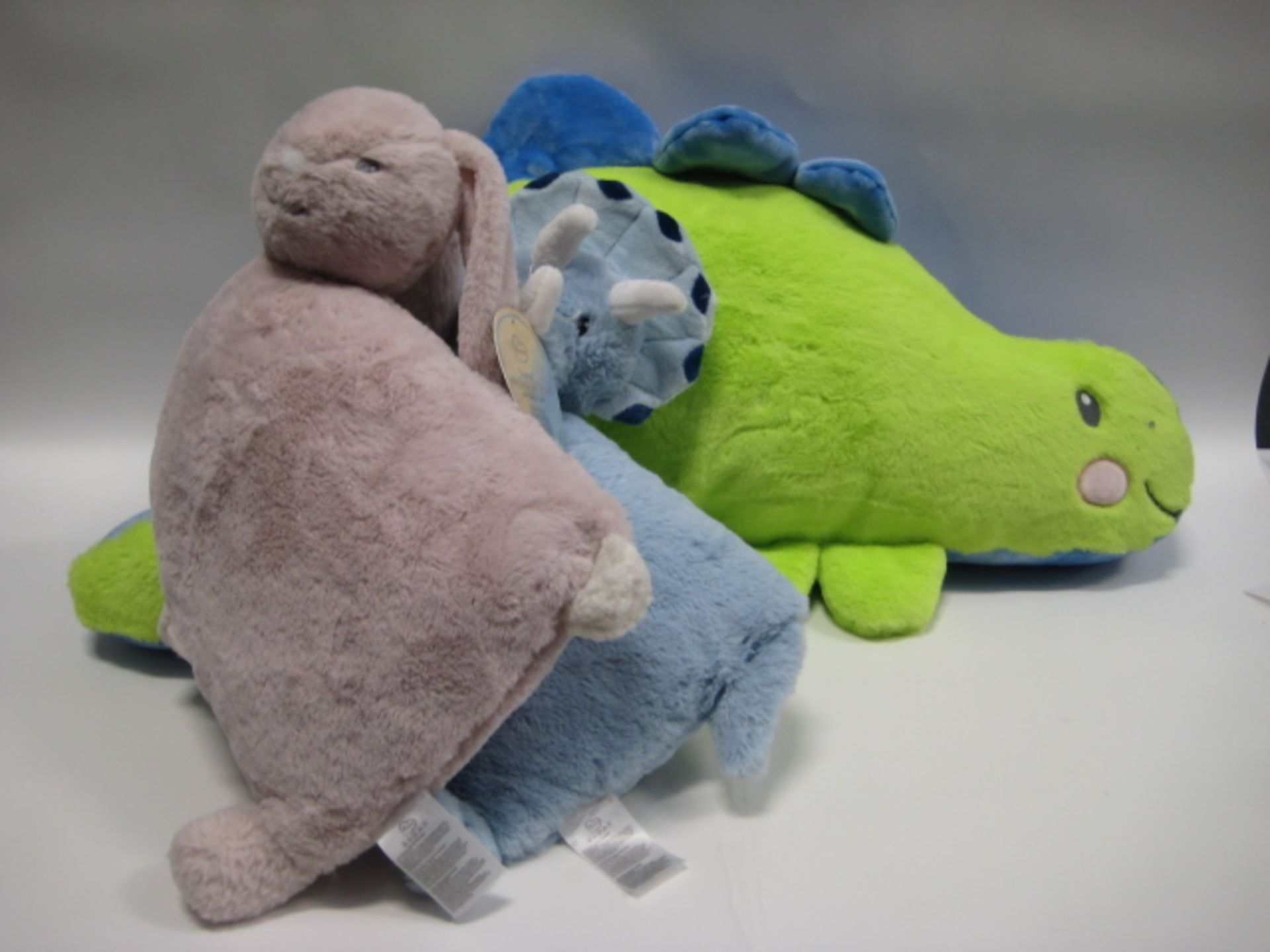 3 children's pillows, 1 as large blue and green dinosaur with rabbit and smaller blue dinosaur