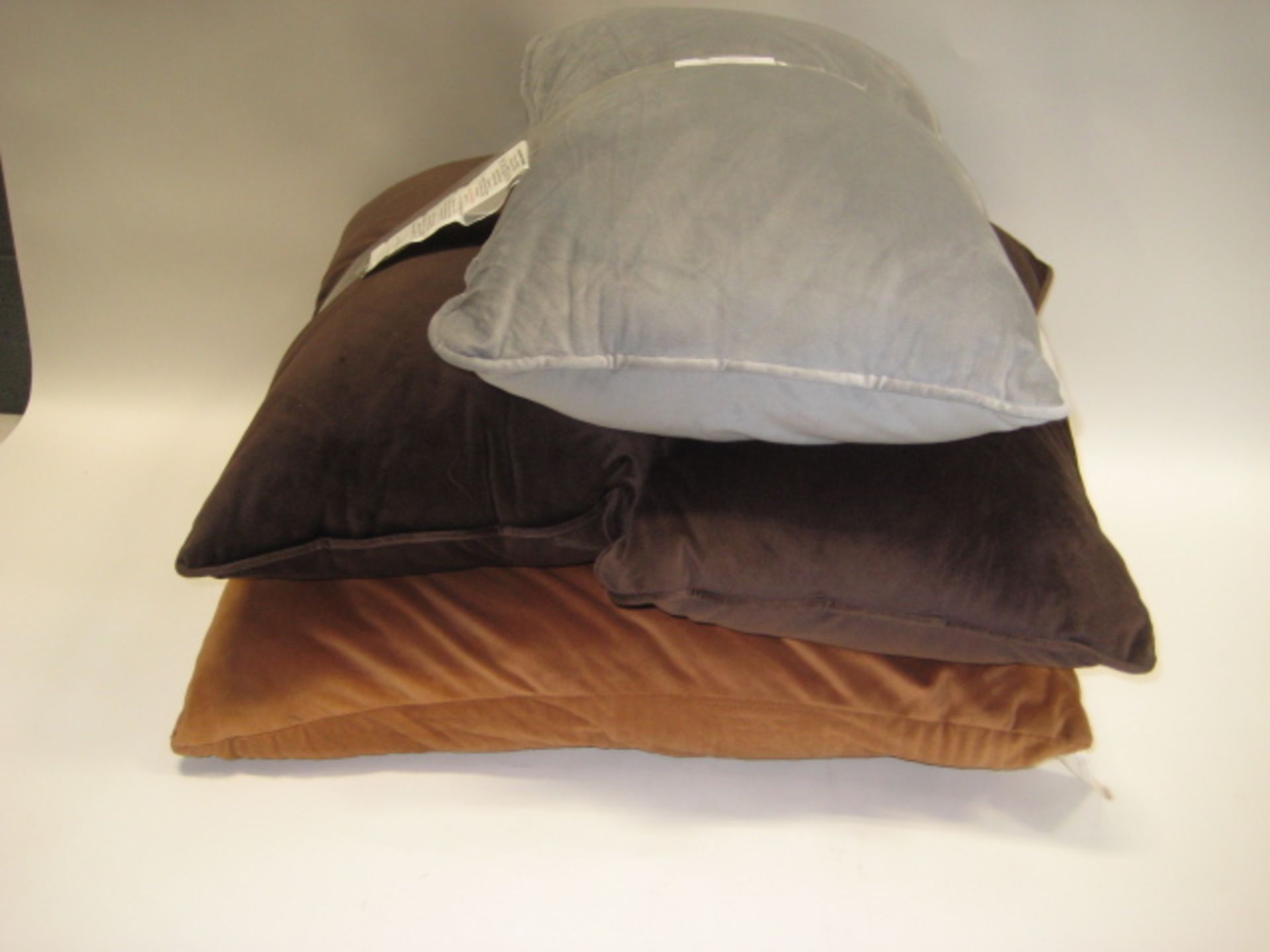 4 various pillows, 1 light brown, 2 dark brown and 1 grey (2 different sizes)