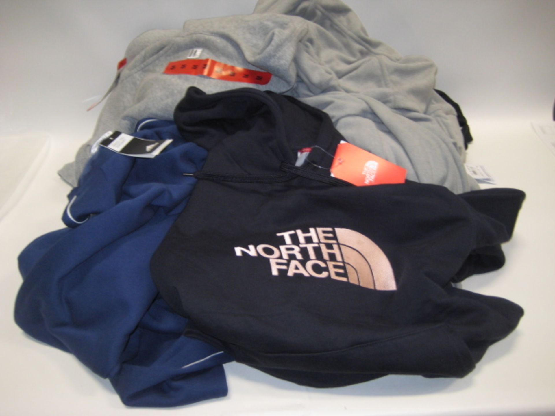 Bag containing ladies and gents jogging bottoms and hoodies in various sizes, colours and styles