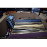 Box containing vinyl records, DVDs and CDs