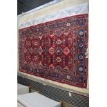 (11) Louis de Poortere Karabagh carpet with red ground and geometric pattern, approx 135 x 210cm