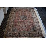 (25) A large Indian Taj Mahal Prado woolen carpet in shades of salmon pink with animal and foliate