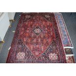 (23) Afghan carpet in red ground and geometric pattern, approx 170 x 260cm
