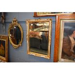 Rectangular bevelled mirror in gilt painted frame