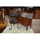 1970's teak magazine rack and a black painted wrought metal side table Fair condition