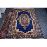 Persian style carpet with blue ground and gold coloured motifs, approx 170 x 240cm