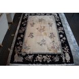 Chinese style carpet with black border and cream ground, approx 170 x 240cm