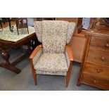 Parker Knoll florally upholstered beech framed wing armchair (See soft furnishing policy)