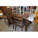 Oak finish extending dining table and 6 ladder back chairs