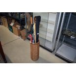 Wicker stick stand, snooker cue, walking sticks and umbrellas