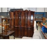 Serpentine fronted floral inlaid and glazed display cabinet with matching corner unit