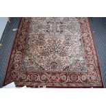 (12) A Persian style carpet in cream ground and red border with foliate motifs, approx 195 x 295cm