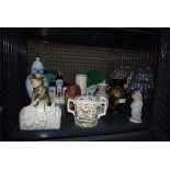 Cage containing majolica plates, Staffordshire figure, Delft lidded vase, figure of an owl,