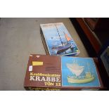 4 boxes and bag containing model kits and miniature hot air balloon