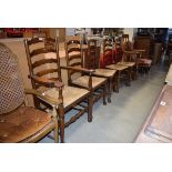 18th century style oak ladder back armchair with strung seat together with 4 matching side chairs