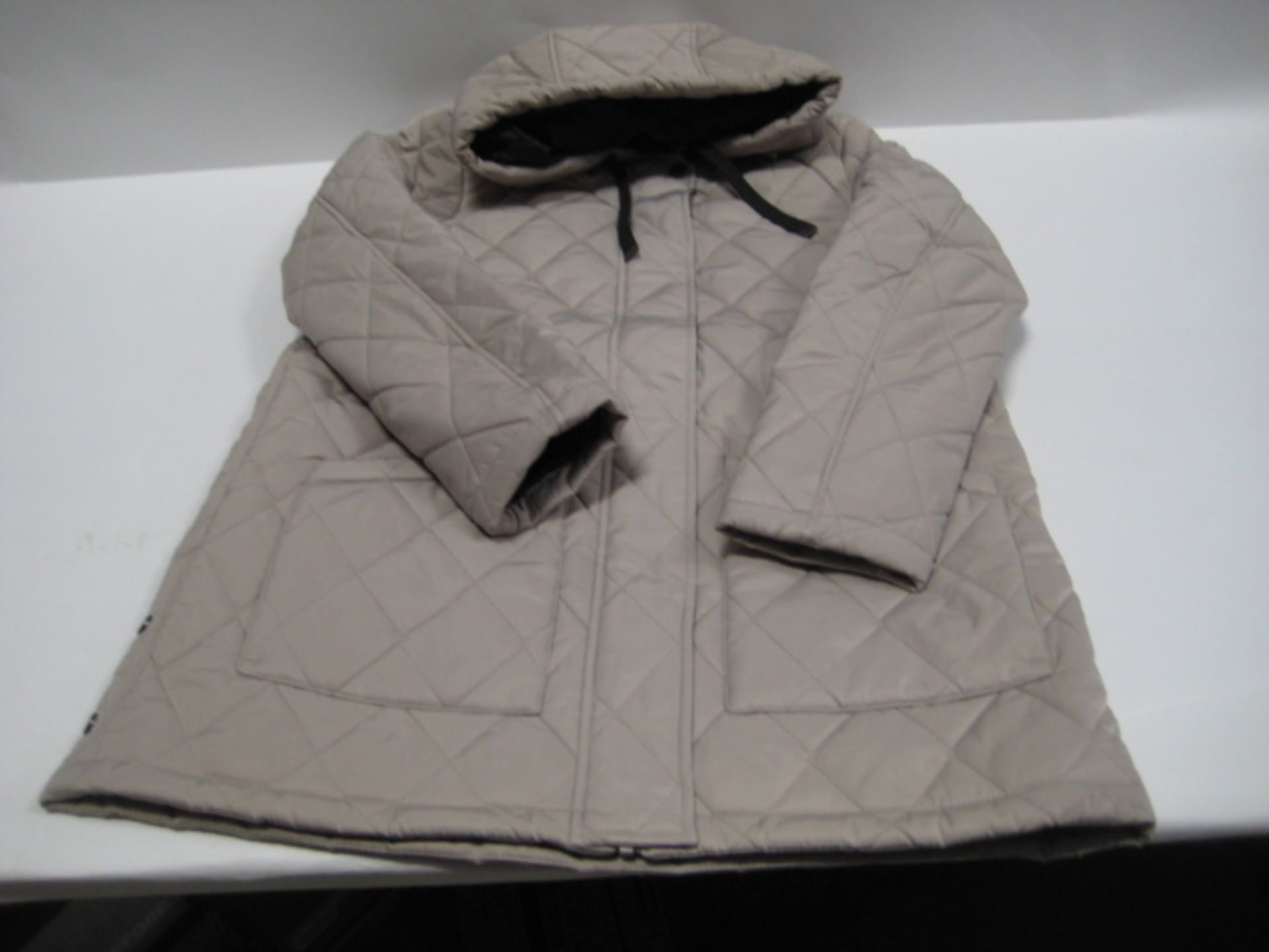 Box containing 16 weatherproof ladies quilted and hooded jackets in light beige