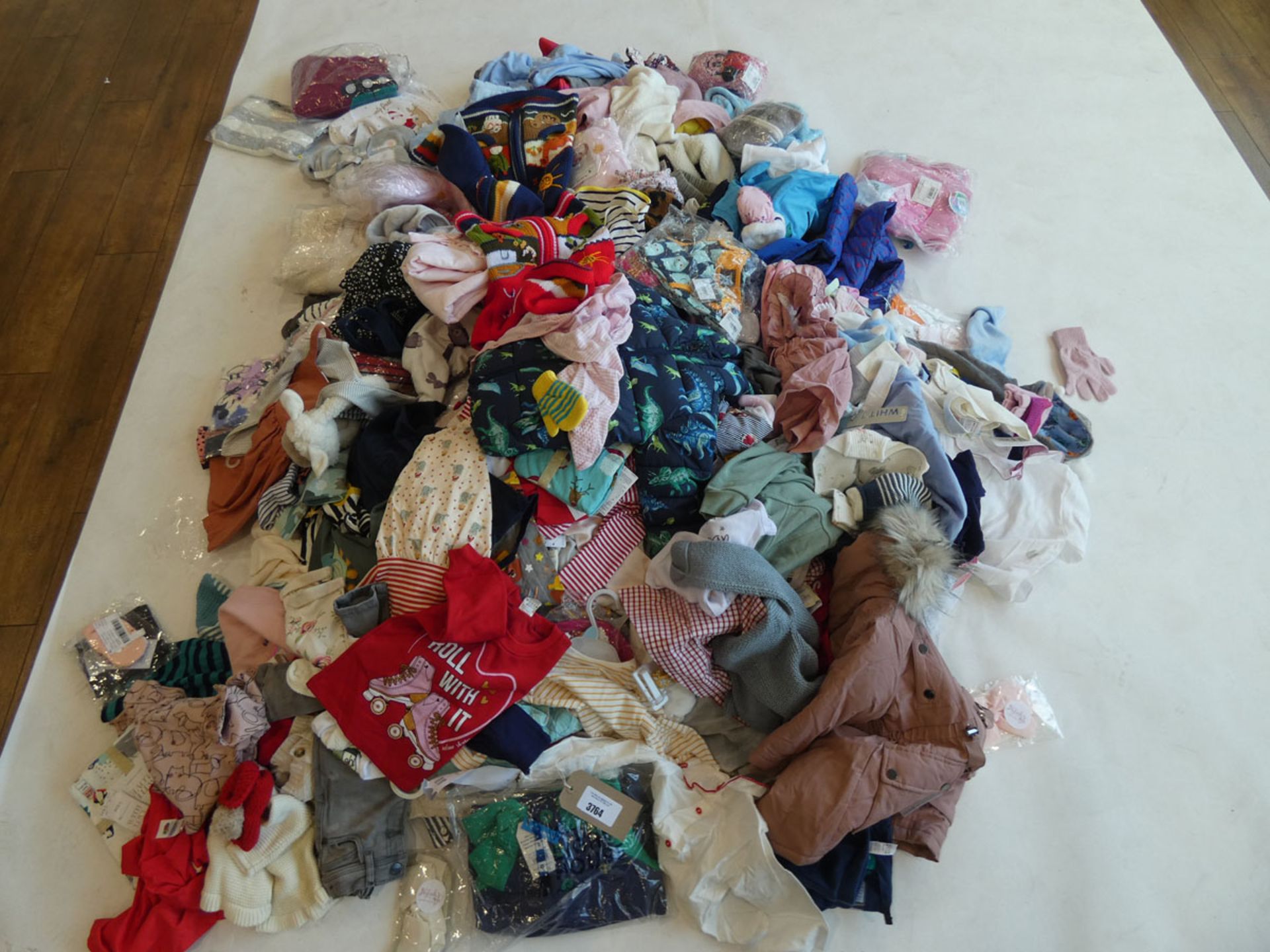 Half a stillage containing children's clothing ages 3 and under Mixed condition