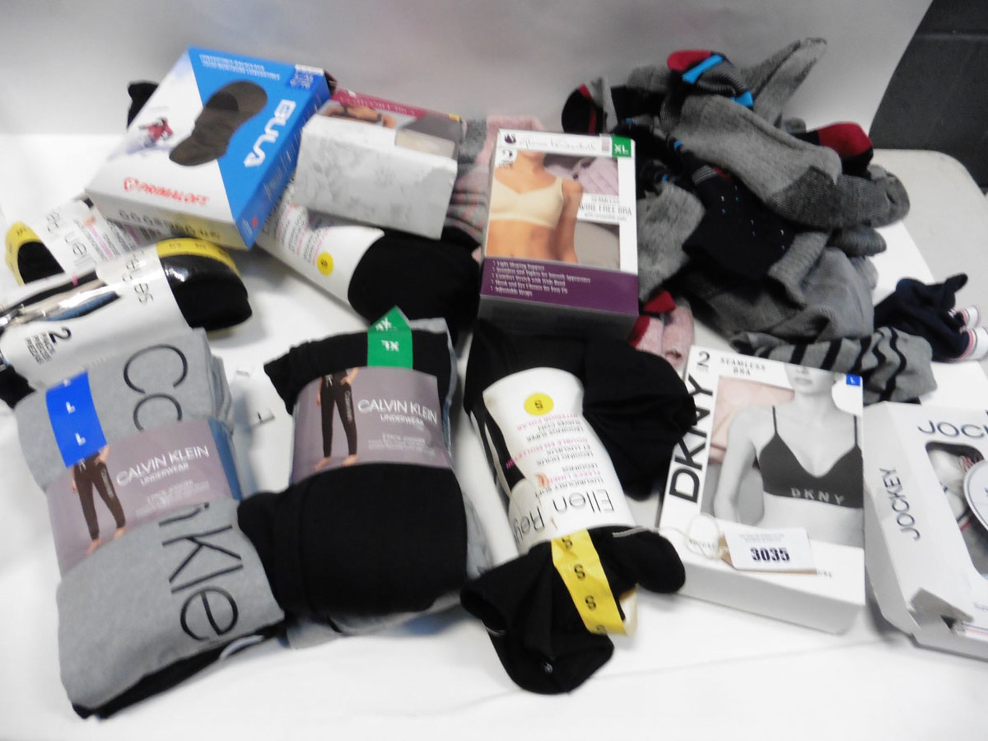 Lot containing some loose pairs of socks, ladies Calvin Klein joggers, leggings, bras etc