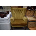 A 1950's gold button upholstered wing armchair on cabriole legs, w. 73 cm *see soft furnishings