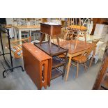 A 1970's tea drop leaf dining table, an oak three tier tea trolley and a mid 20th century sewing