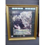 Framed and glazed print of lady in garden