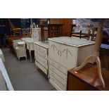 A quantity of cream painted bedroom furniture comprising cabinet, dressing table, chest, narrow