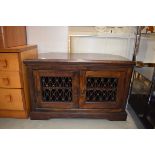 A modern Jali corner TV cabinet with metalwork doors, w. 88 cm