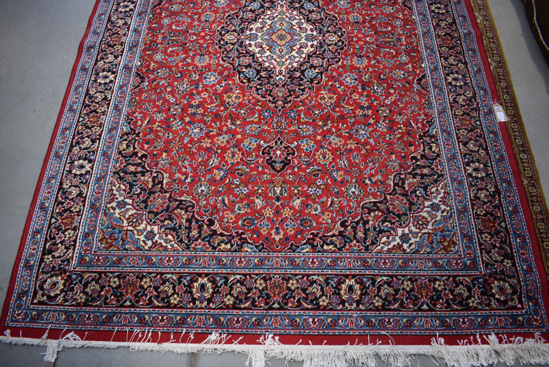 (11) An Iranian Pamchal carpet, red ground and blue border with Persian style foliate decoration