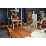 A set of four Ercol elm seated 'wishbone' kitchen chairs and a matching rectangular dining table