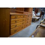 A large modern pine finish chest of eight long drawers, w. 165 cm