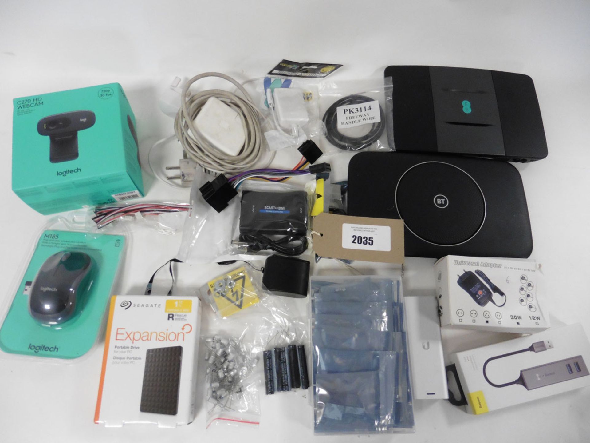 A bag of various adaptors, components, routers, portable hard drive, webcam, etc.