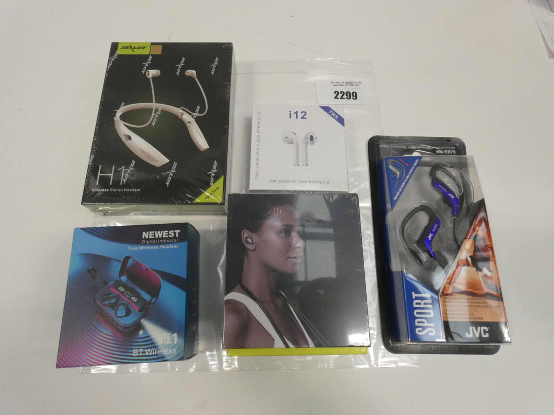 Bag containing Various wireless earbuds including Newest V5.1, Zealot sport, JVC HA-EB75 earphones.