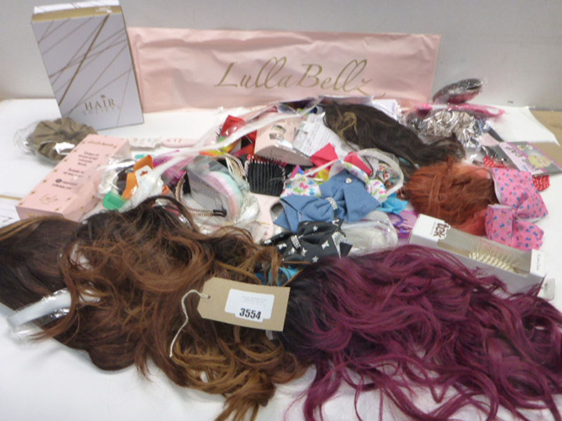 Selection of wigs, hair pieces, hair brushes and hair accessories