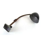 A Bauhaus-era desk lamp with a black plastic shade and flexible shaft,
