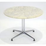 An occasional table, the circular marble surface resting on an aluminium frame,