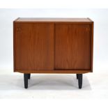 A Danish teak cabinet, the two sliding doors enclosing two compartments and three drawers,