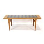 A 1960's Danish oak and tile set coffee table on tapered legs, w.