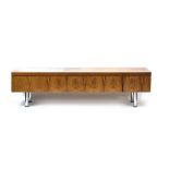 A 1960's rosewood lowboy with three frieze drawers on aluminium legs, l.