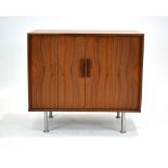 A 1970's teak cabinet with concertina doors on spun aluminium legs, w.