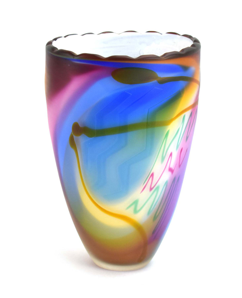 A Chris Comins studio glass vase with relief chevrons, layered abstract lines and a white interior,