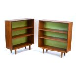A pair of 1970's G-Plan teak open bookcases on turned legs, w.