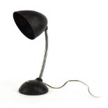 A Bauhaus-era desk lamp with a bakelite shade and flexible shaft CONDITION REPORT: