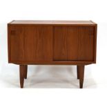 A low Danish teak cabinet, the two sliding doors enclosing two shelved compartments,