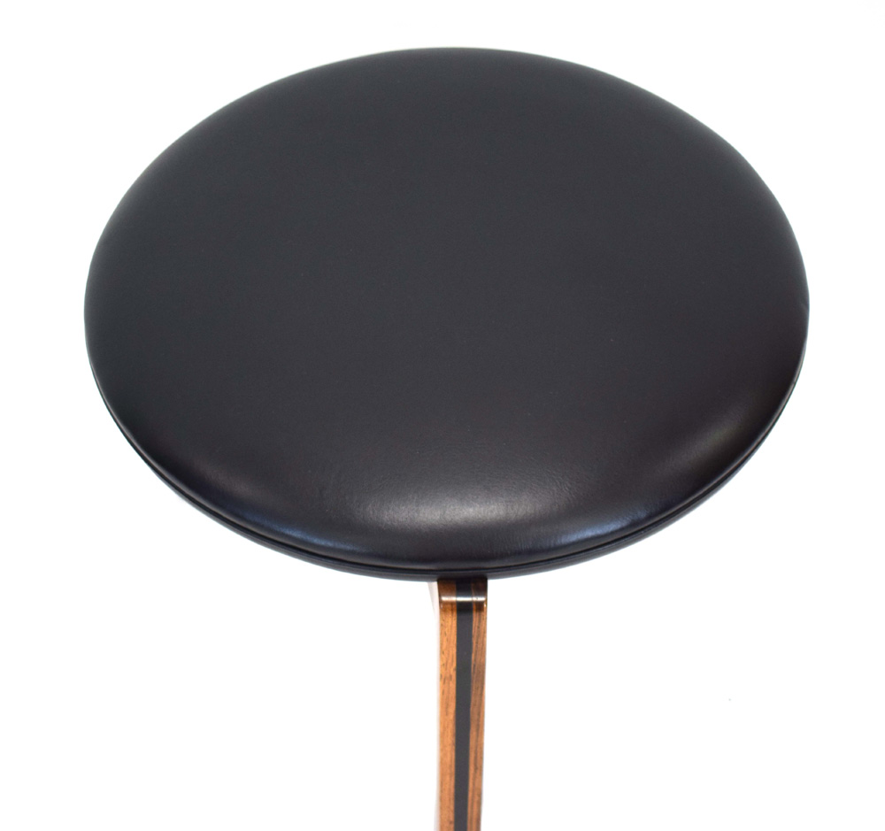 A 1960's rosewood and ebonised stool with black upholstery over a tri-form base *Sold subject to - Image 2 of 7