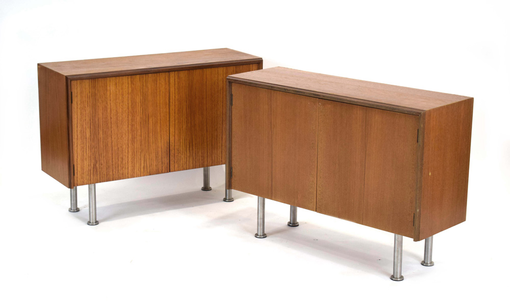 A pair of G-Plan teak low cabinets, each with a pair of doors on later spun aluminium legs, w.