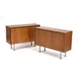 A pair of G-Plan teak low cabinets, each with a pair of doors on later spun aluminium legs, w.