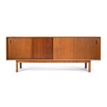 A 1960's Danish teak sideboard, the two sliding doors enclosing five drawers and shelving,