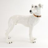 An Italian pottery figure modelled as a greyhound in white, labelled 'For Parrots, C.S.M.